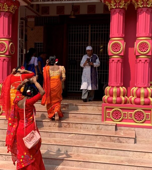 Women in sarees in front of Hindu temple
